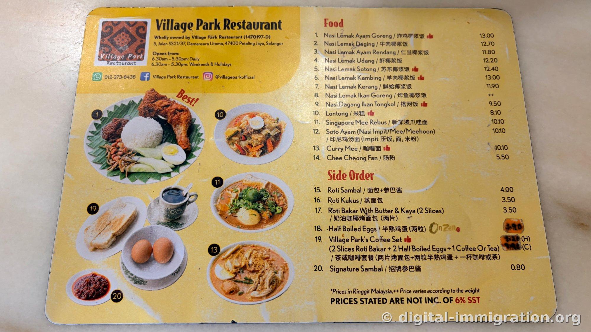 Yellow menu board at Village Park Restaurant. Address, operating hours, and prices for different types of nasi lemak and side menu prices are printed with photos of signature dishes