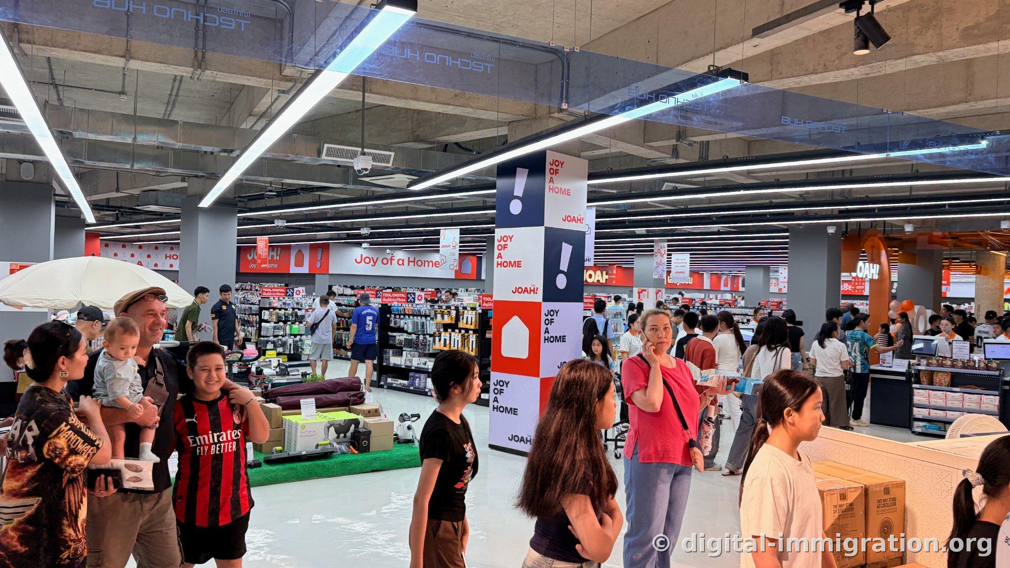 Red and navy JOAH! 'Joy of a Home' column advertising with tools and household goods displays, TECHNO HUB sign on ceiling