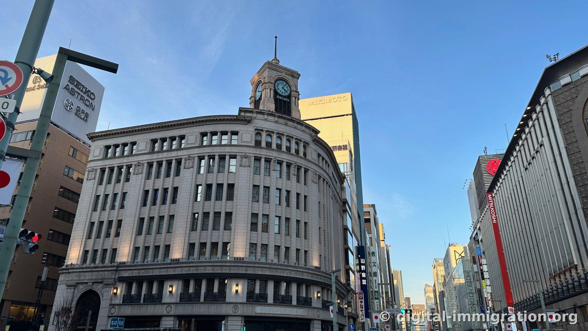 Wako building at Ginza 4-chome intersection on clear day with Mitsukoshi Ginza and Matsuya Ginza signs to right