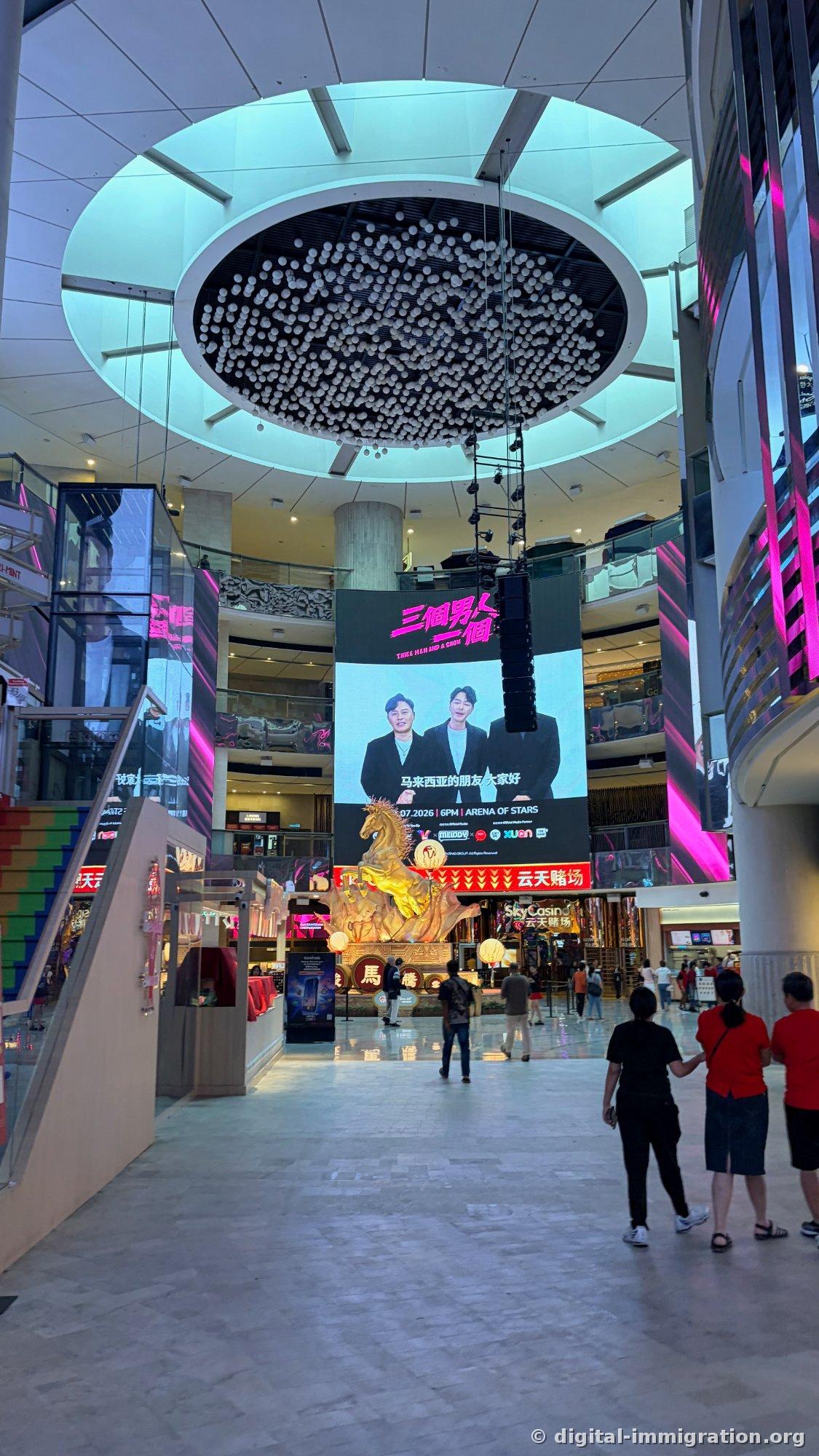Night-lit indoor street with Din Tai Fung 鼎泰豐 shop on left and large cat face-shaped archway with CAT ALLEY sign in center