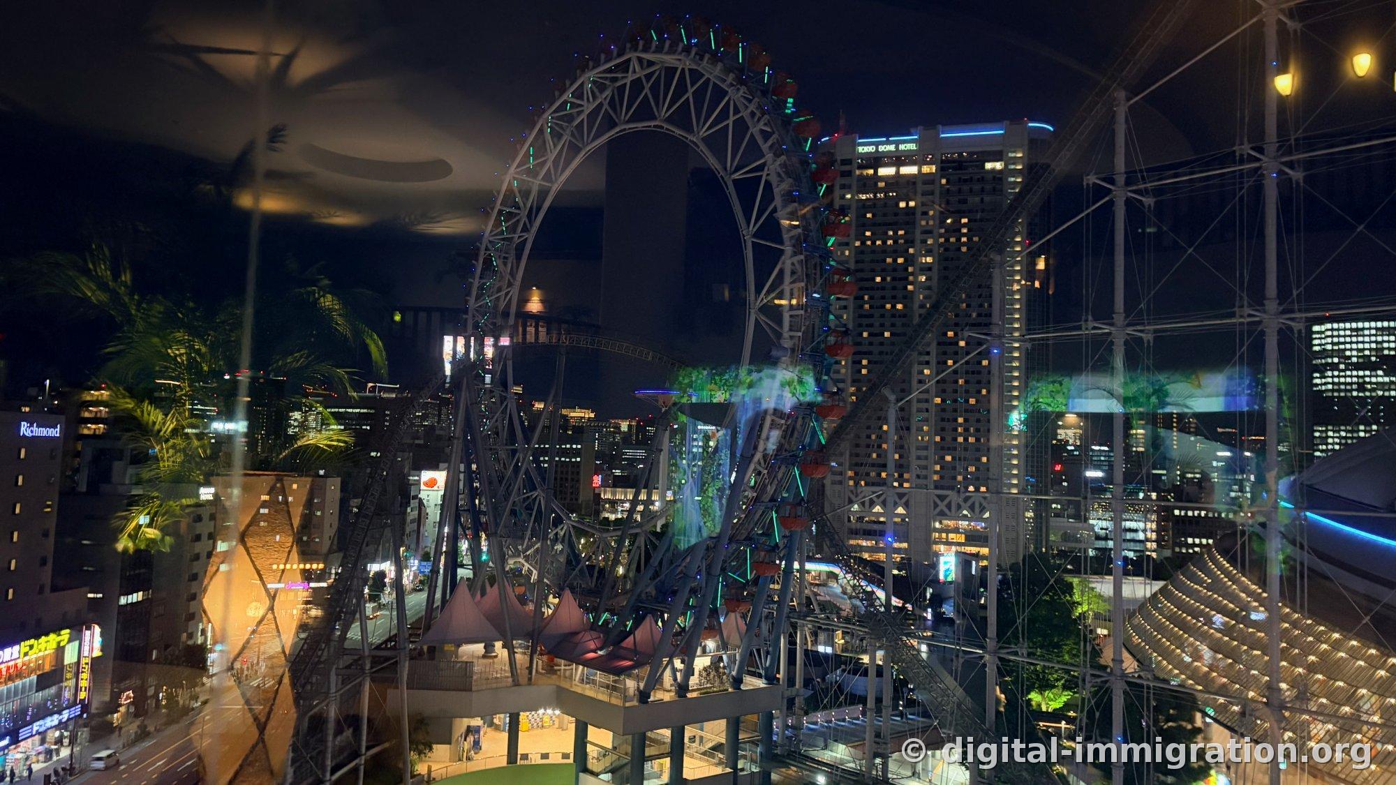 夜景の中、青緑に輝く大観覧車と灯った'TOKYO DOME HOTEL'看板の高層ホテル、左にドン・キホーテネオン