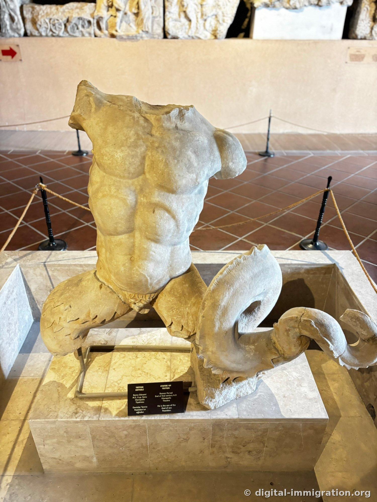 Triton statue with muscular human upper body and split fish tail for lower half, head and arms missing