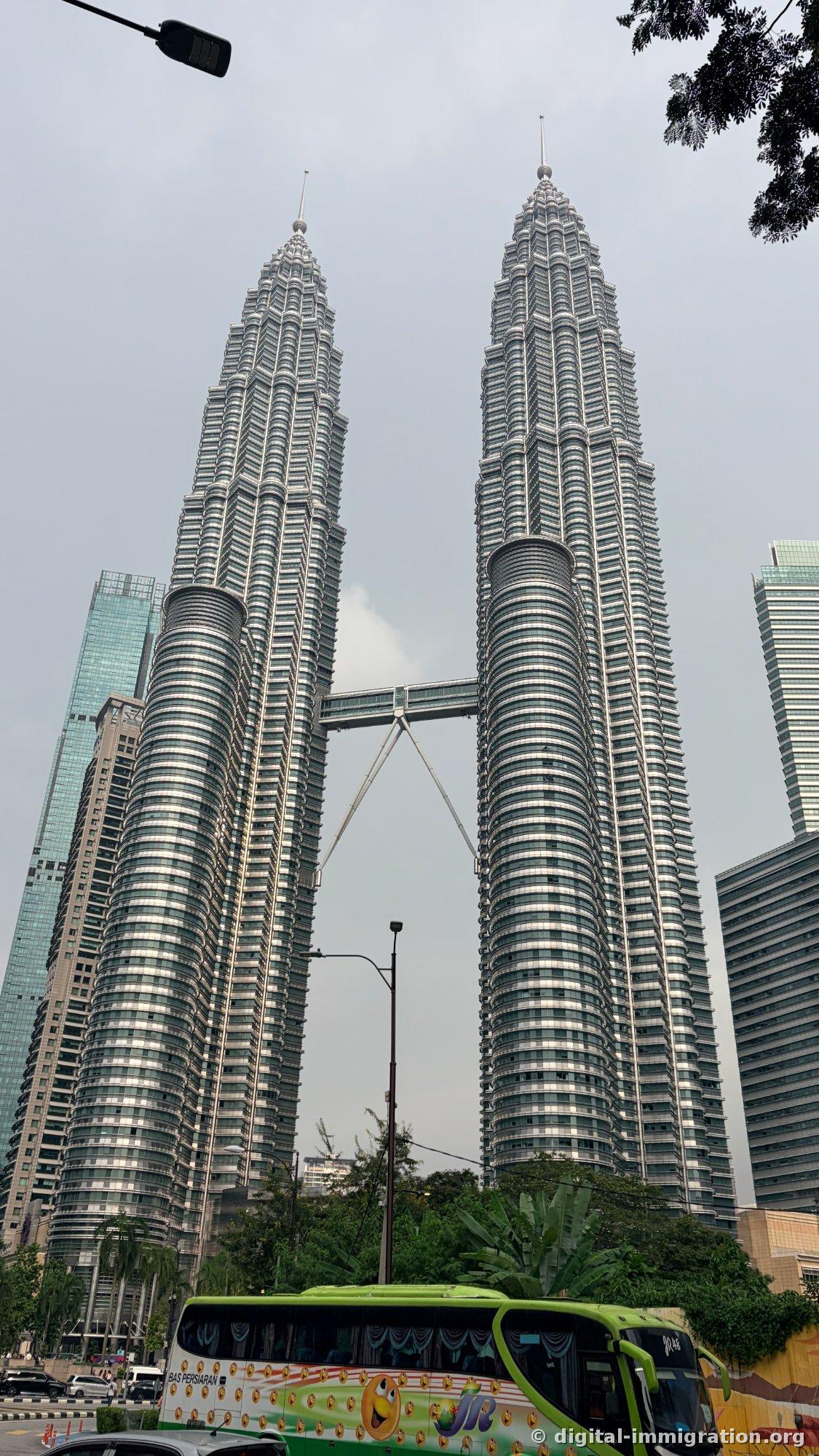 The Twin Towers in daylight. Tourist buses stop frequently like the green one in the photo, so full-length shots are better from the opposite side of the road.