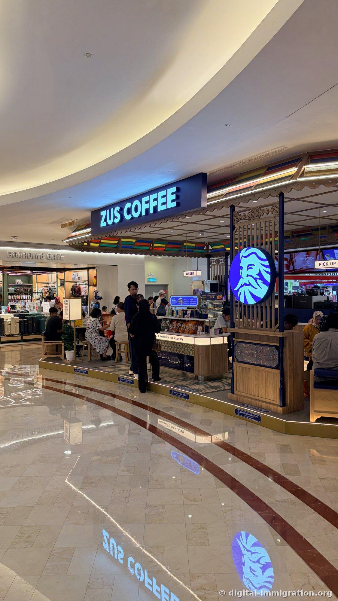 The ZUS Coffee kiosk inside the mall. QR code ordering is standard, and the wait line is always about this long.