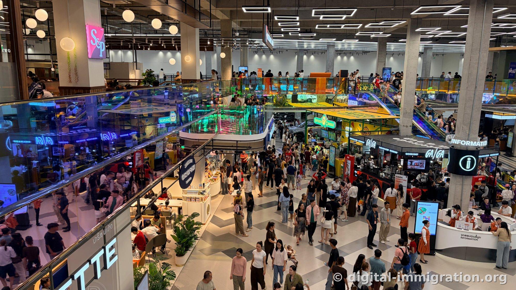 View of ground floor central hall from second floor railing, S&P signage and Potato Corner, GAGA, information desk with crowds