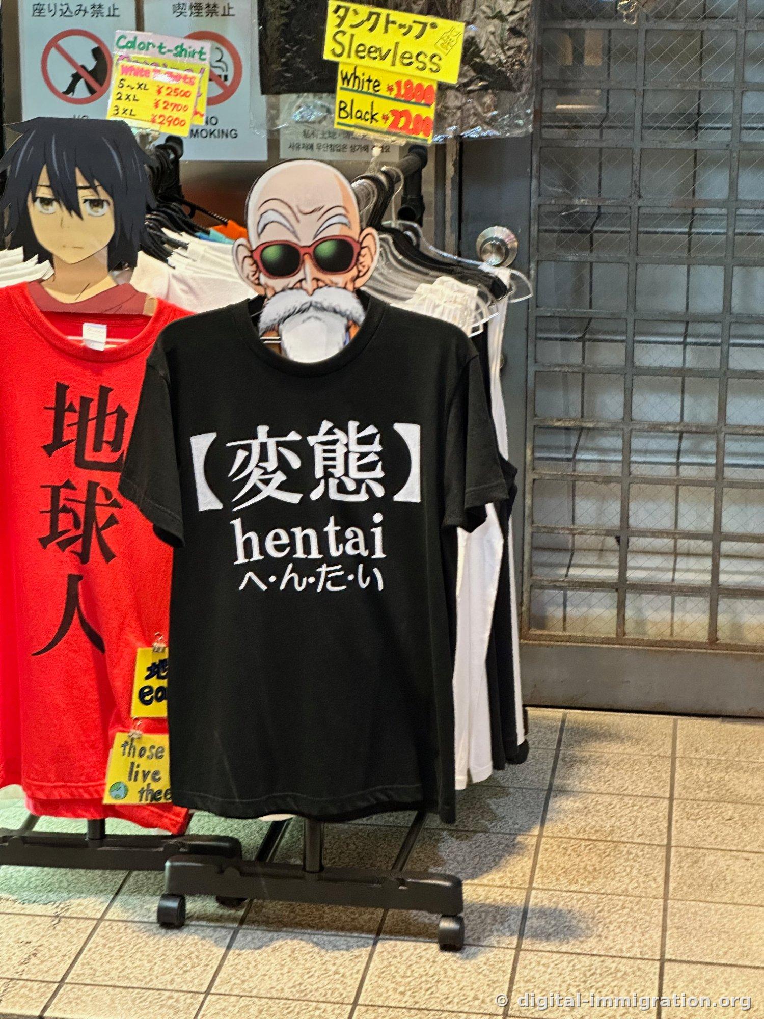 Street-side clothing rack with black '変態 hentai' t-shirt and red 'earthling' t-shirt, yellow price guide