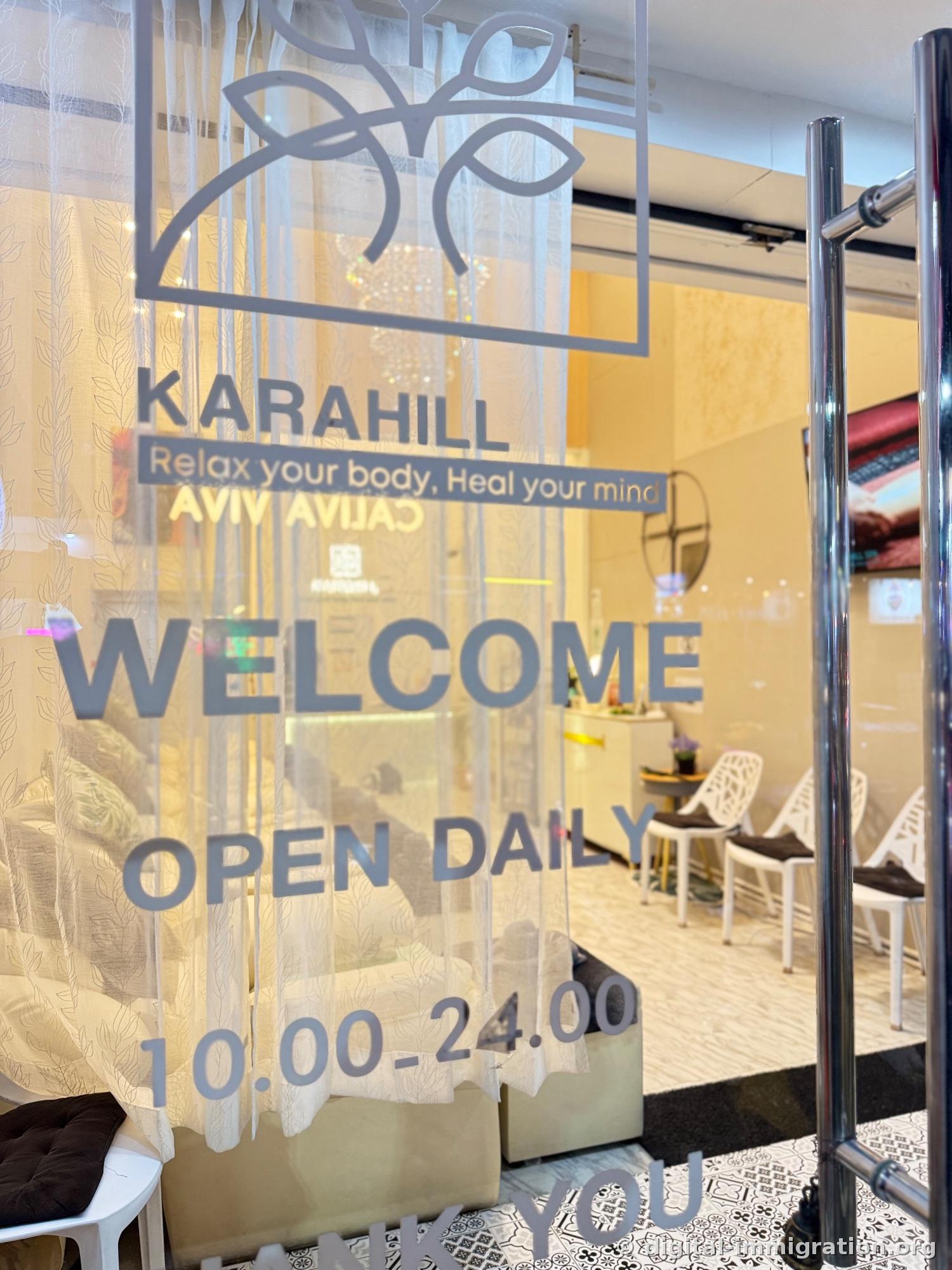 KARAHILL logo etched in gray on the glass door with text 'Relax your body, Heal your mind', 'WELCOME OPEN DAILY 10.00-24.00'