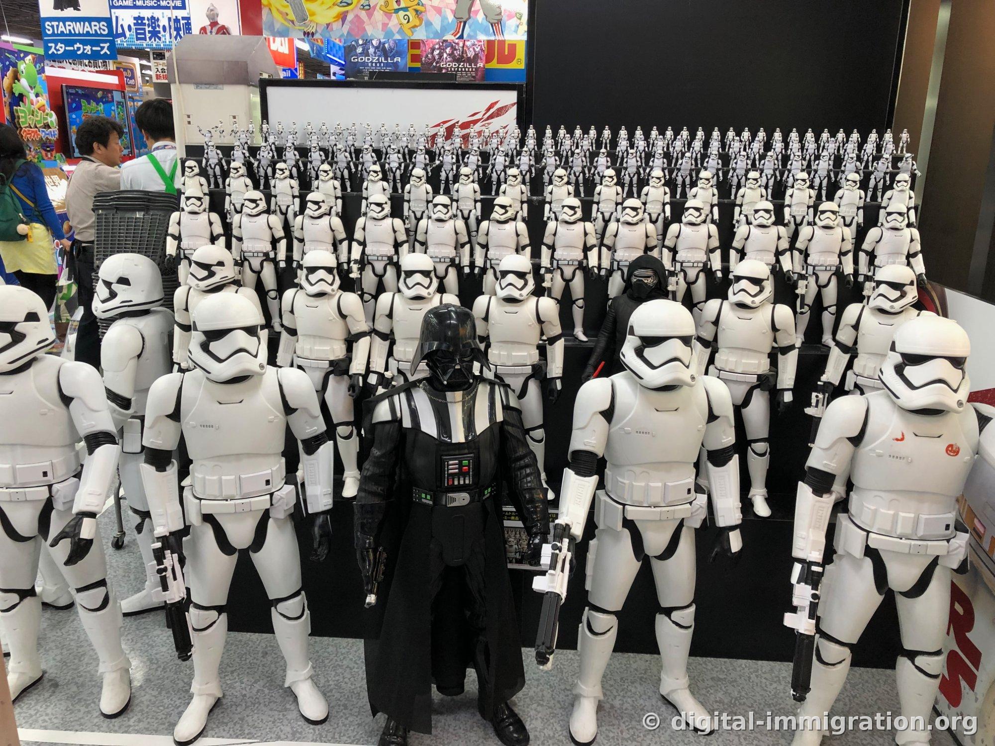 Large number of Stormtrooper figures stacked in tiers in the store with Darth Vader in the front