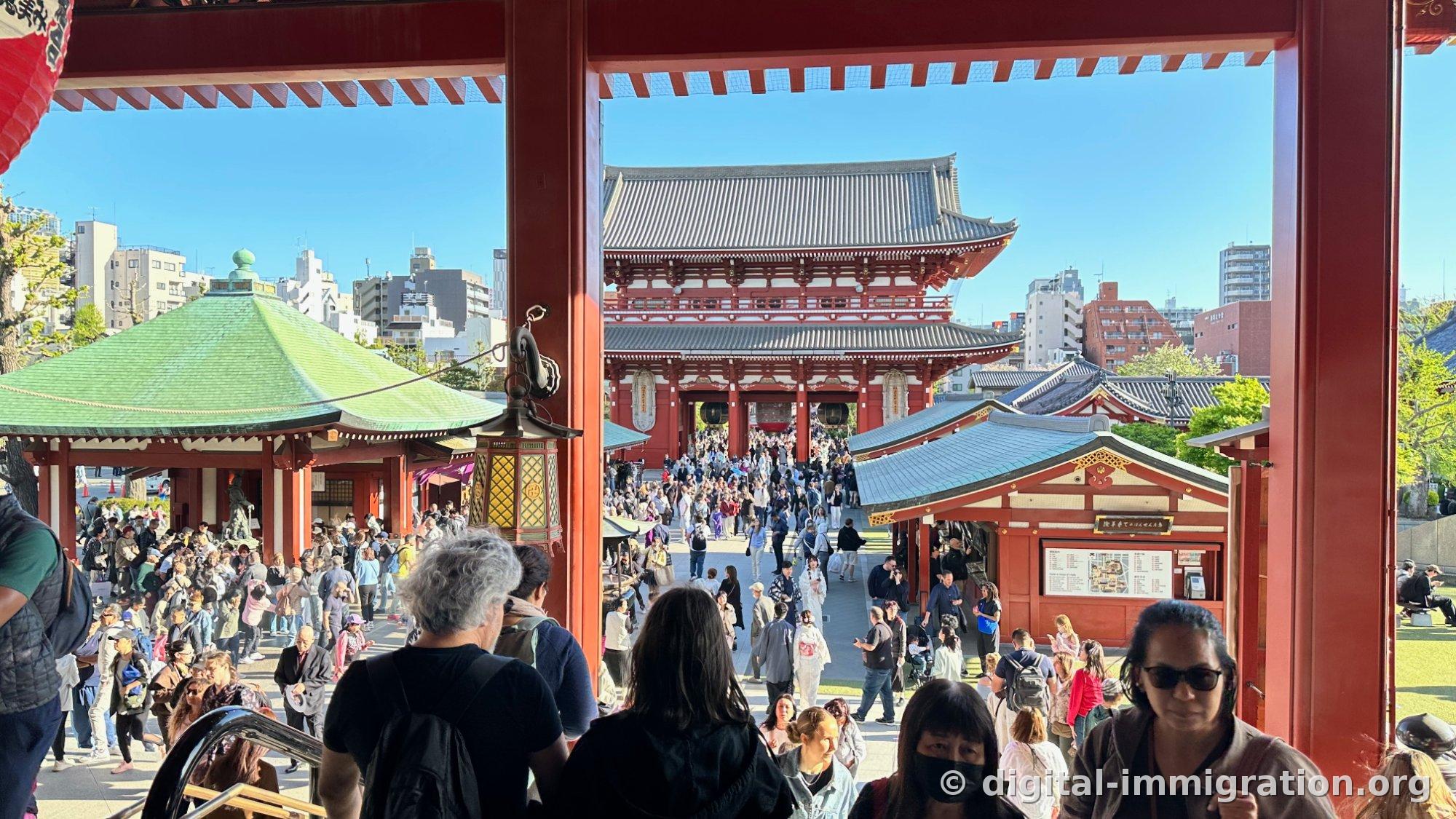 Hozomon and approach viewed from the top of the main hall steps, with a blue-green roofed hall visible on the left